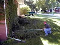 John C Wray III measuring for landscaping at the house on maple drive